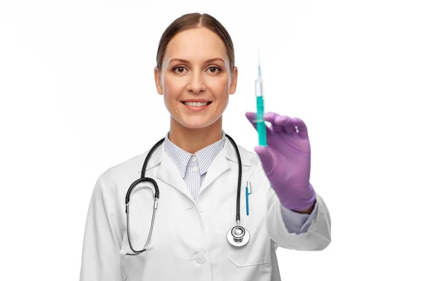 Happy female doctor with medicine in syringe — Stock Photo, Image