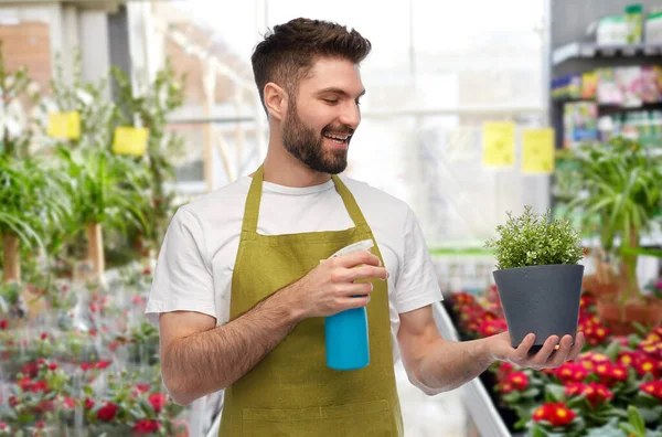 Gelukkig mannelijk tuinman hydraterende bloem in winkel — Stockfoto