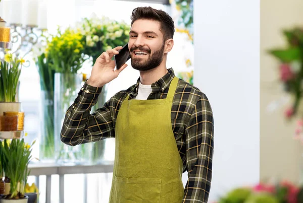 Vendedor masculino chamando no smartphone na loja de flores — Fotografia de Stock