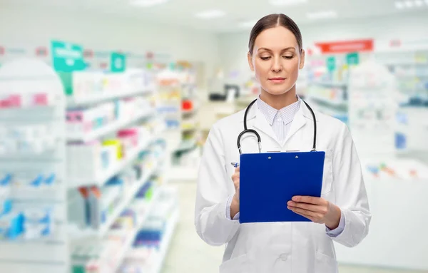 Medico con appunti e stetoscopio in farmacia — Foto Stock