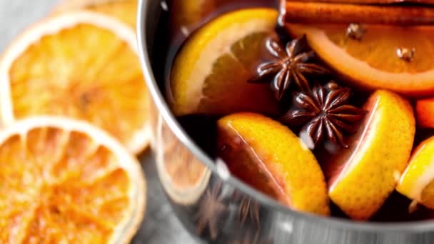 Close up of hot mulled wine with orange and spices — Stock Video