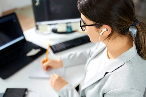 Zakenvrouw met koptelefoon werken op kantoor — Stockfoto