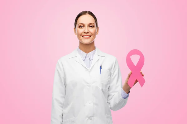 Female doctor with breast cancer awareness ribbon — Stock Photo, Image