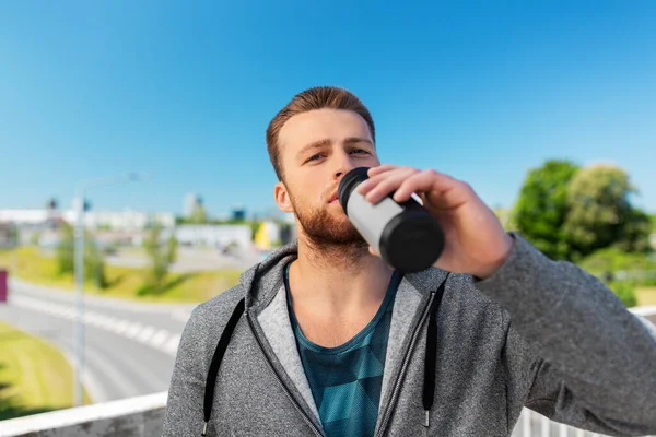 Young man with sports bottle — Stock Photo, Image