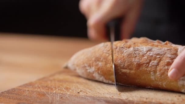 Kvinnlig bagare skära hembakat bröd på bageri — Stockvideo