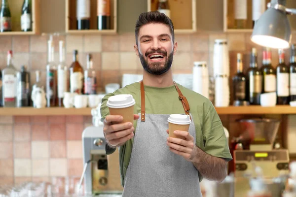 Gelukkig glimlachende barman in schort met afhaalkoffie — Stockfoto