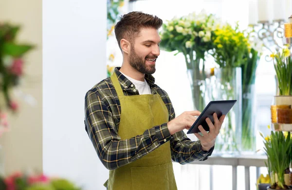 Happy male gardener or farmer with tablet pc — Stock Photo, Image