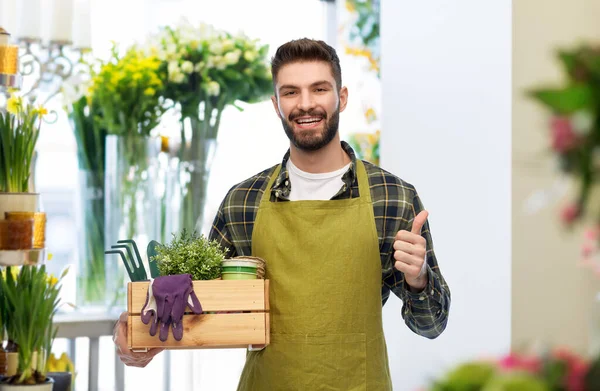 Happy gardener or farmer with box of garden tools — Stock Photo, Image