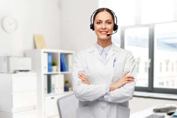Smiling female doctor with headset at hospital — Stock Photo, Image