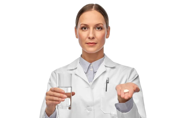 Female doctor with medicine and glass of water Stock Image