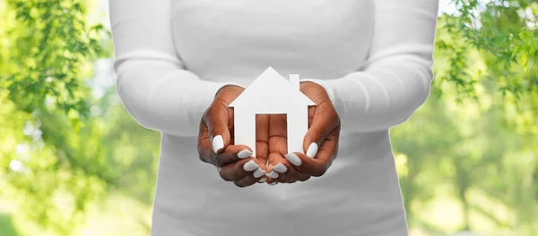 Hands of african american woman holding house — Stock Photo, Image