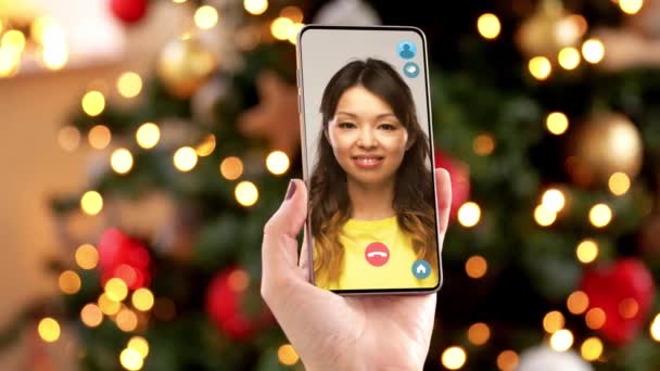 Woman with smartphone has video call on christmas — Stock Video