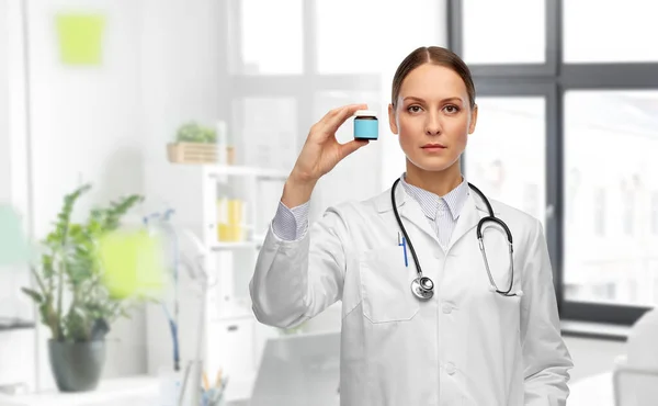 Женщина-врач держит банку с лекарствами в больнице — стоковое фото