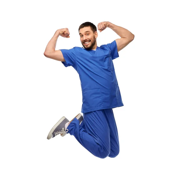 Счастливый улыбающийся врач или медбрат, прыгающий в воздух — стоковое фото