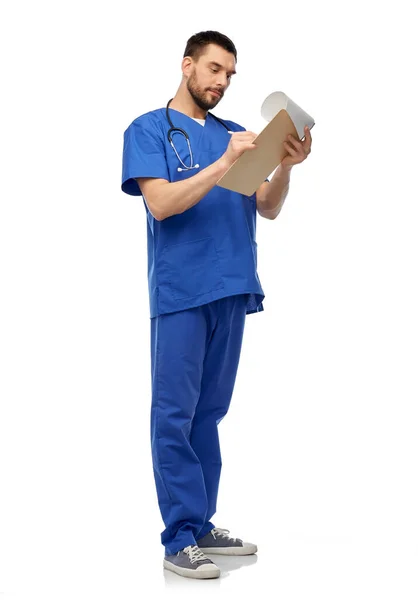 Doctor masculino escribiendo informe médico en portapapeles — Foto de Stock