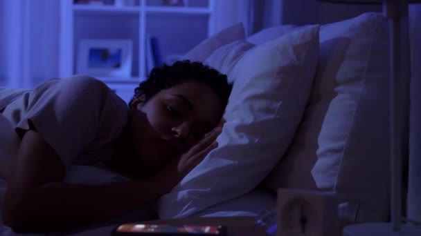 Mujer dormida despertando por teléfono por la noche — Vídeos de Stock