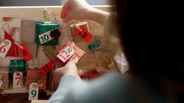 Hands making christmas advent calendar at home — Stock Video