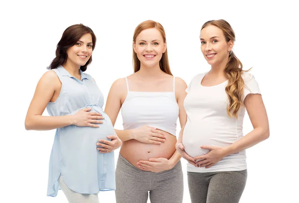 Happy pregnant women touching their big bellies — Stock Photo, Image