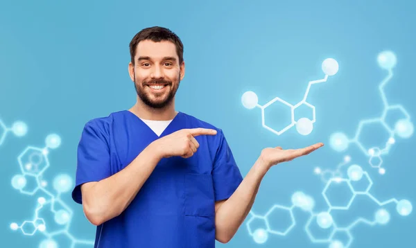 Smiling male doctor showing molecule formula — Stock Photo, Image