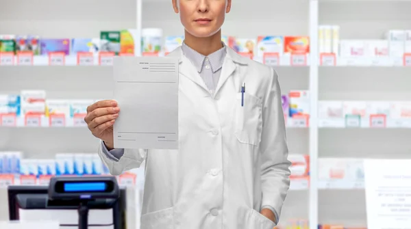 Ärztin mit Rezept-Blanko in Apotheke — Stockfoto