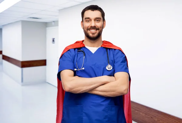 Doctor or male nurse in superhero cape at hospital — Stock Photo, Image