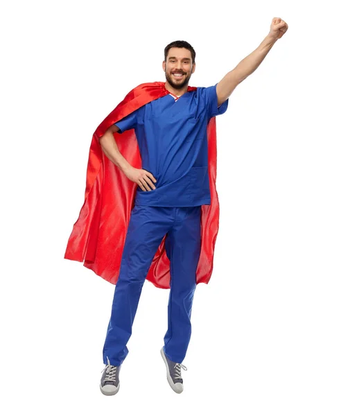 Doctor or male nurse in superhero cape flying — Stock Photo, Image