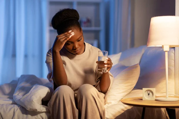 Mulher africana estressado deitado na cama à noite — Fotografia de Stock