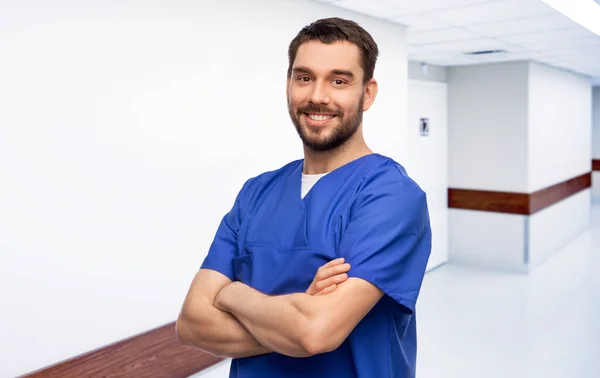 Gelukkig lachende arts of mannelijke verpleegkundige in blauw uniform — Stockfoto