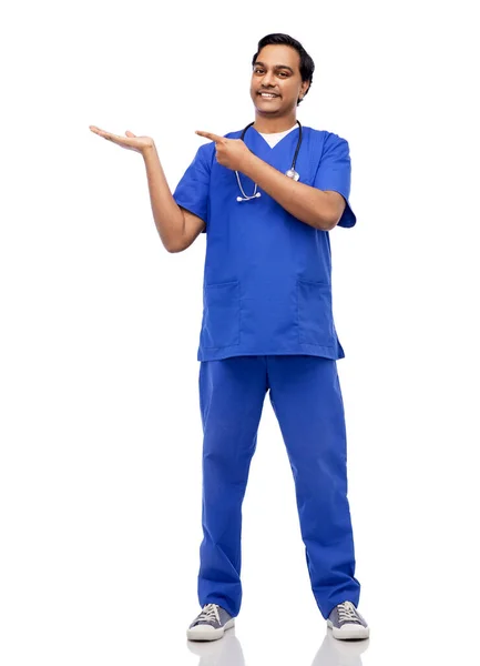 Happy indian male doctor holding something on hand — Stock Photo, Image