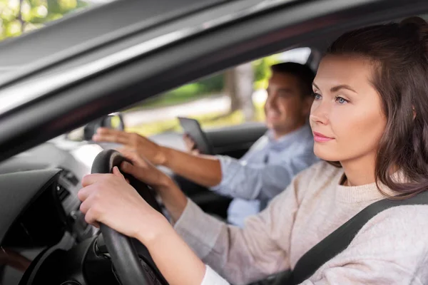 car driving school instructor teaching woman