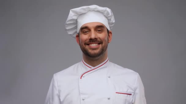 Happy smiling male chef adjusting toque — Stock Video