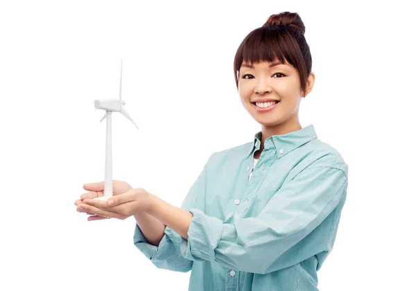Усміхнена молода азіатська жінка з іграшковою вітровою турбіною Ліцензійні Стокові Фото