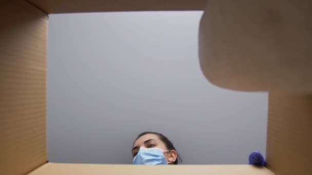 Γυναίκα σε συσκευασία μάσκας με είδη καθαρισμού — Αρχείο Βίντεο