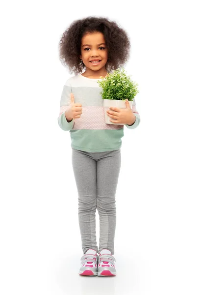 Smiling girl holding flower and showing thumbs up — Stock Photo, Image