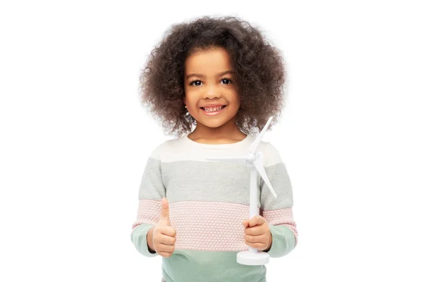 Happy african american girl with toy wind turbine — Stock Photo, Image