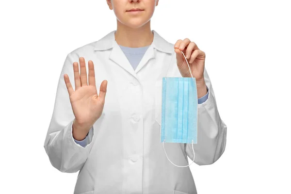 Médico feminino com máscara mostrando gesto parar Imagens Royalty-Free