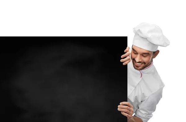 Šťastný usměvavý samec kuchař s velkou černou tabulí — Stock fotografie