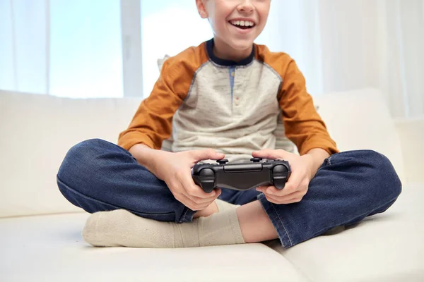 Menino feliz com gamepad jogar videogame em casa — Fotografia de Stock