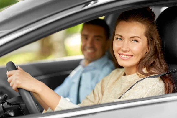 Car driving school instructor teaching woman Stock Image