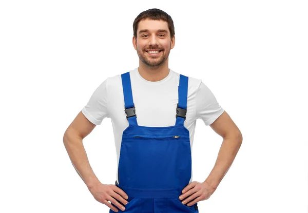 Happy smiling male worker or builder in overall — Stock Photo, Image