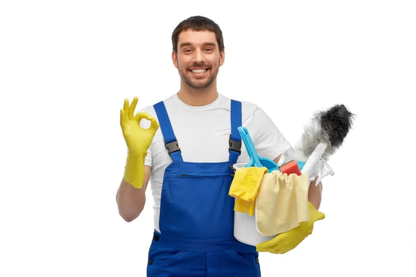 Male cleaner in overall with cleaning supplies — Stock Photo, Image