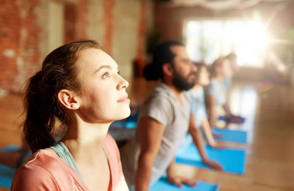 Group of people doing yoga cobra pose at studio — Stock Photo, Image