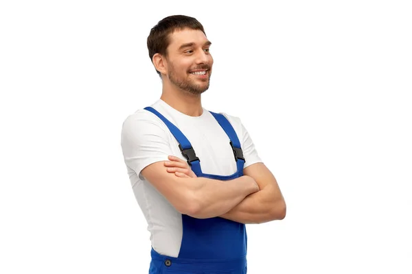 Happy smiling male worker or builder in overall — Stock Photo, Image