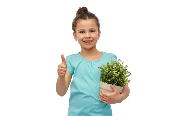 Sorridente menina segurando flor e mostrando polegares para cima — Fotografia de Stock