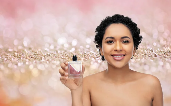 Young african american woman with perfume — Stock Photo, Image