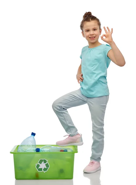 Smiling girl sorting plastic waste showing ok sign — Stock Photo, Image