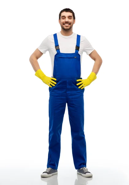 Happy male worker or cleaner in overal and gloves — Stock Photo, Image