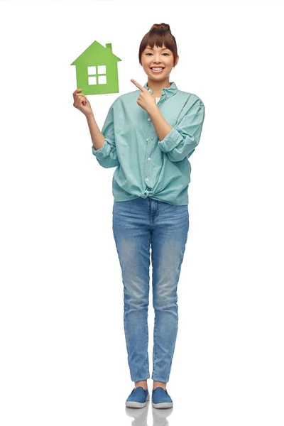 Smiling asian woman holding green house — Stock Photo, Image