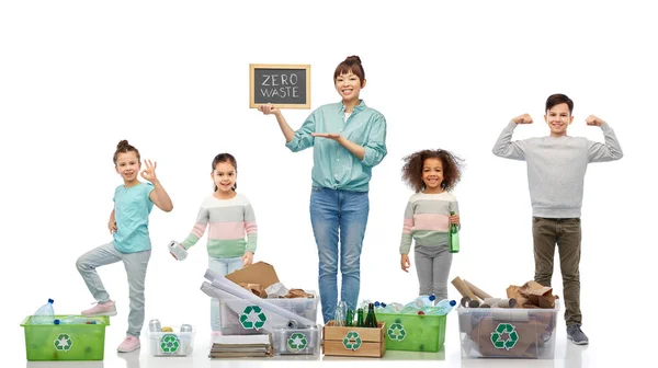 Happy woman with little children sorting waste — Stock Photo, Image