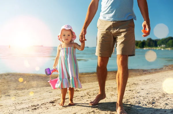 Отец гуляет с маленькой дочерью на пляже — стоковое фото